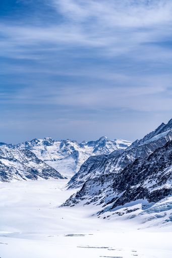 A vertical shot of the snowy Schilthorn mountains in the Jungfrau Region of Switzerland