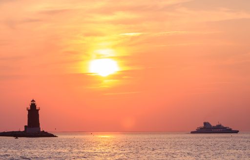 The Delaware Breakwater East End Lighthouse and Cape May-Lewes Ferry against sunset