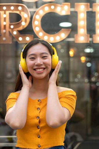 asian woman listening to music with her headphones