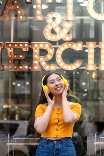 happy asian woman listening to music with her headphones
