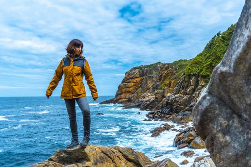 A beautiful shot of a couple on a trekking trip by the sea on Monte Urgul in the city of San Sebastian, Gipuzkoa. Basque Country