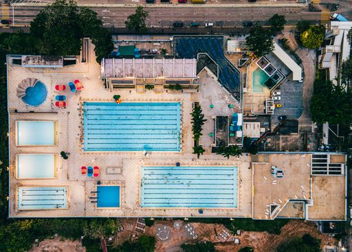 An aerial view of outdoor swimming pools on a roof in Hong Kong