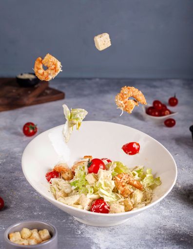 A vertical shot of a tuna salad in a white bowl