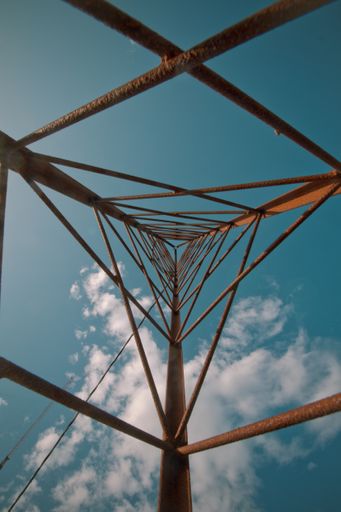 A low angle shot of a tall metal building under a beautiful cloudy sky