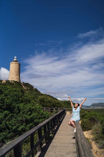 A vertical shot of a female near the Faro de Camarinal