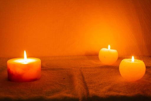 A closeup shot of burning candles on dark background