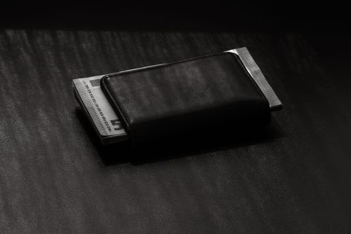 A grayscale shot of stack of euro banknotes in a wallet on table
