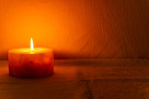 A closeup shot of burning candles on dark background