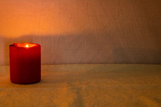 A closeup shot of burning candles on dark background