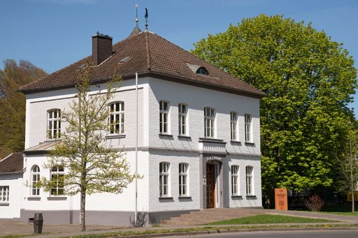 A building in village Odenthal with townhall and trees at springtime, Bergisches Land, Germany