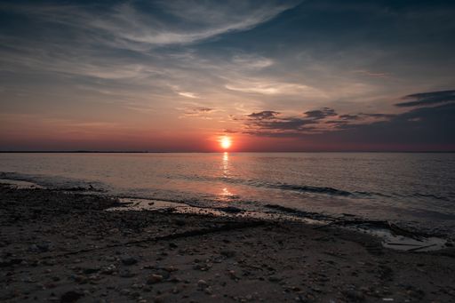 A scenic view of a colorful sunset over the Delaware Bay from New Jersey