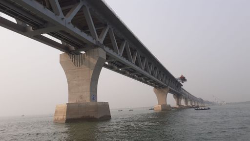 A long bridge over the water on a foggy weather