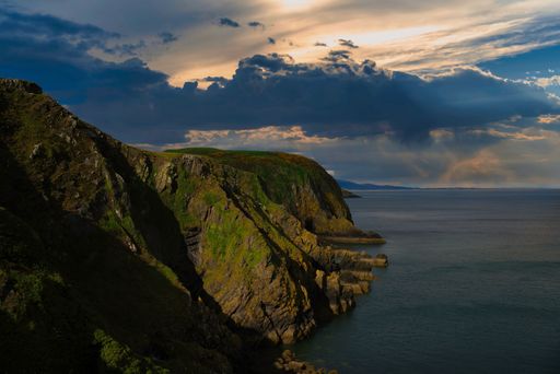A mesmerizing shot of a landscape with water near during the sunset