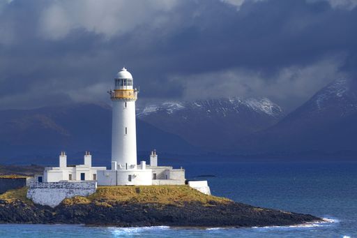 A scenic view of Lismore lighthouse on the coast of the Isle of Mull, Scotland