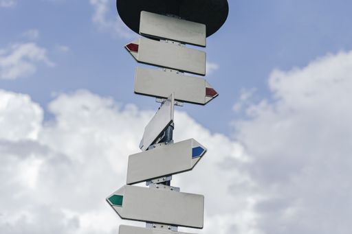 Trail signs with empty space for copy. Wooden trekking or hiking sign pointing in different directions. Signs on outdoor path.