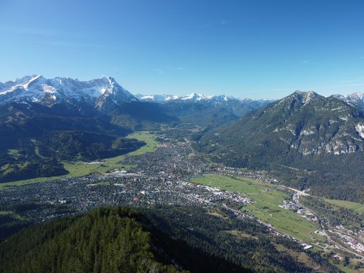 An aerial shot of Garmisch-Partenkirchen town surrounded by Wank mountain in Bavaria, southern Germany