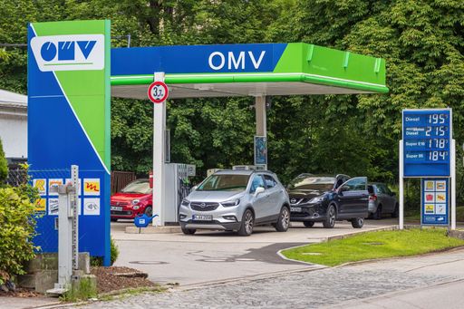A view of cars and the price panel at OMV gas station in Munich