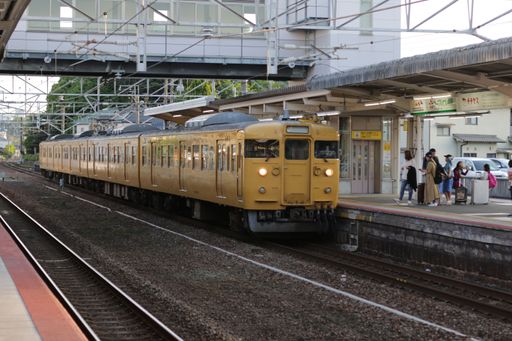 An old yellow train at the station