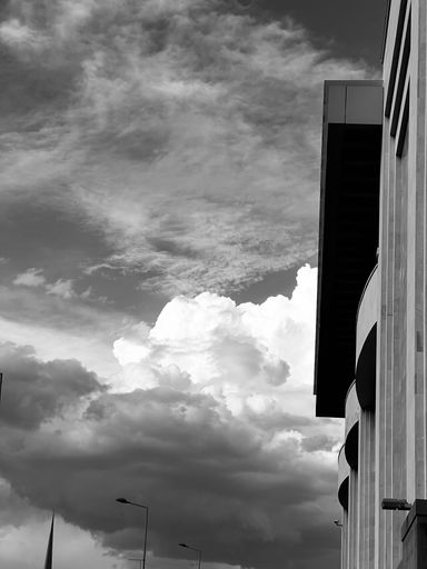A vertical grayscale side view of a modern building in Yerevan, Armenia