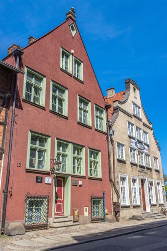A vertical shot of old dated apartments under the blue sky in Gdansk, Poland