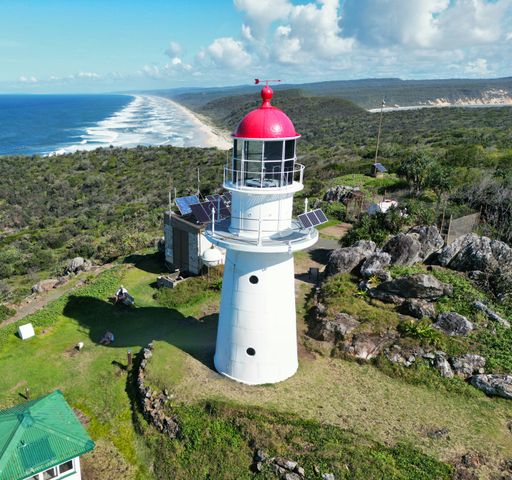 A high angle shot of the Double Island Point Lighthouse at the summit of Double Island Point, Queensland, Australia