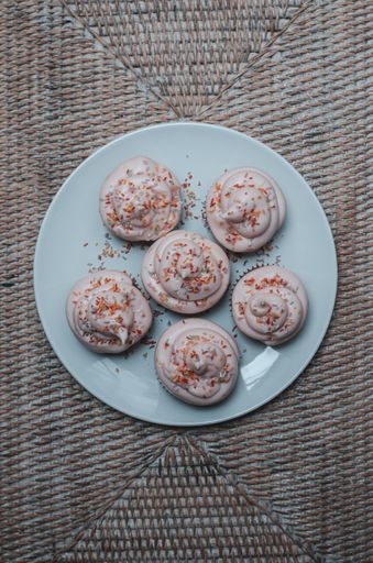 A vertical shot of chocolate cupcakes with a sprinkle toppings  on a blue plate