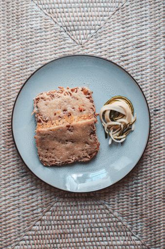 A top view of melted cheese on toast with onions on a blue plate