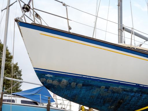 View of Small yacht on dry dock stand being repaired