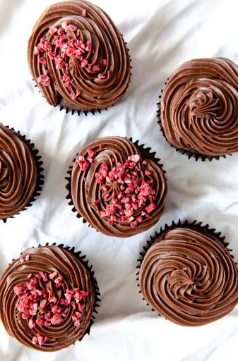 A vertical high angle shot of delicious chocolate cupcakes on a white surface