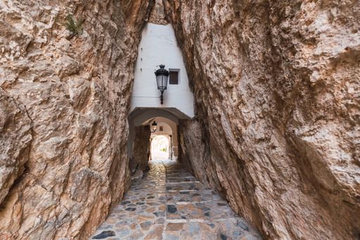 A mesmerizing shot of a path among the rocks leading to Guadalest castle in Spain