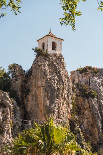 A mesmerizing shot of a famous Bell Tower on top of the rock at Guadalest castle in Alicante,Spain