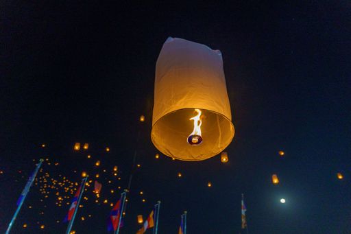 A low angle of a lantern flying in the night sky during Chum Ben festival near Phnom Penh, Cambodia
