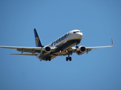 A Ryanair aircraft 737 flying on a blue sky and ready to land at Madrid airport