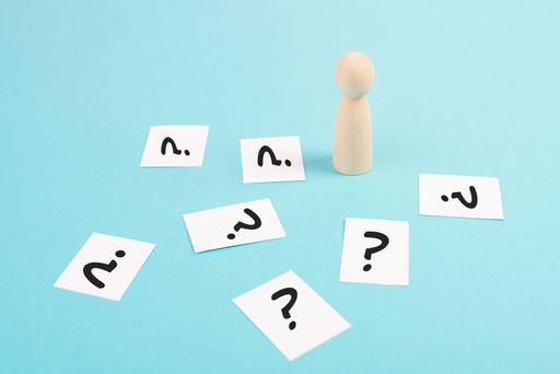 Man is thinking, question marks, brainstorming and looking for answers, solving a problem, making a decision, business and education concept
