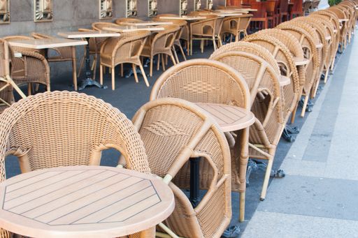 The empty cafe tables chairs on Gran Via street
