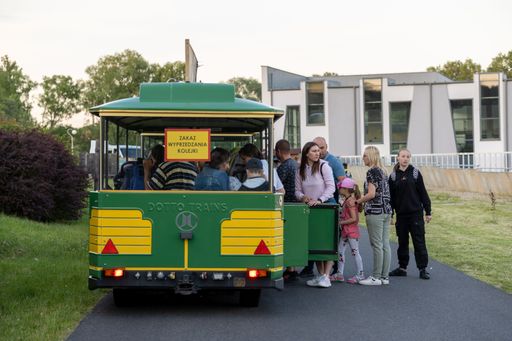 People standing by and inside a small colorful train in the new zoo, Poznan, Poland