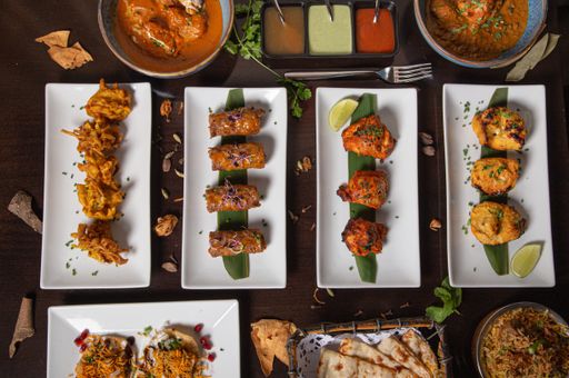 A dinner table with fried meat dishes and sauces
