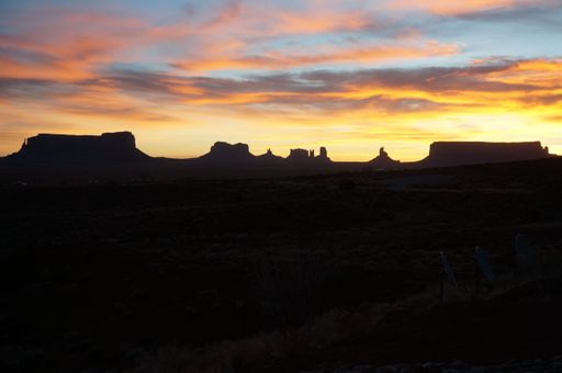 A beautiful silhouette of the mountain valleys in sunset under a colorful cloudy sky