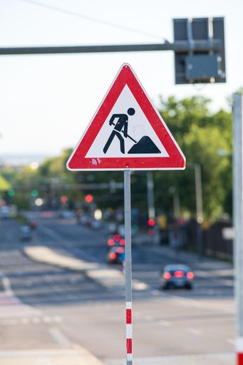 A vertical selective focus shot of under construction road signage in the street