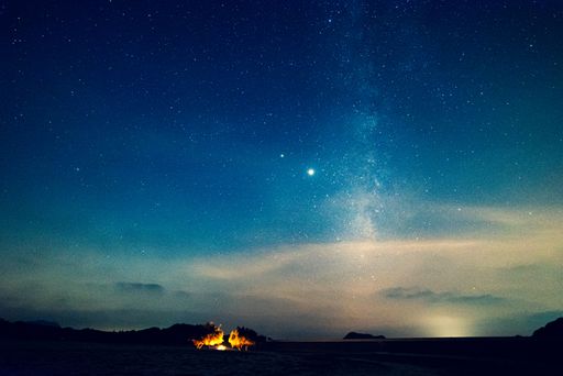 A beautiful view of a field with a starry night sky
