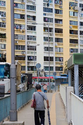 A vertical shot of the people walking in the street at Wah Fu Estate on a sunny day