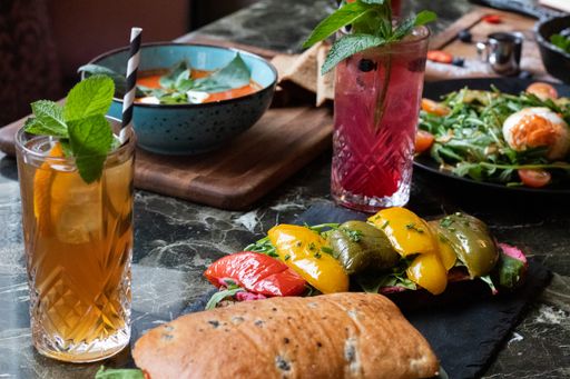 A high angle shot of a traditional sandwich with fresh vegetables on a stone table
