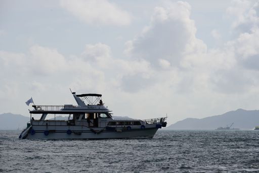 A yacht riding on Waterfall Bay water on a cloudy day