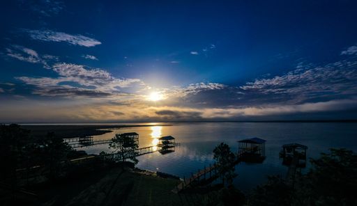 A beautiful sunrise over Perdido Bay with piers and docks below