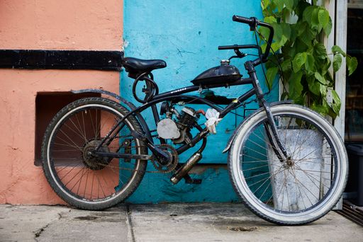 A closeup shot of a bicycle leaned on a colorful building