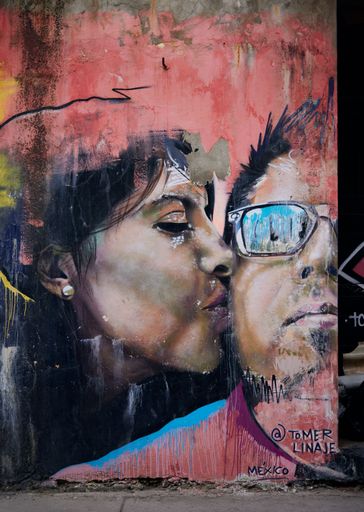 A vertical shot of graffiti art of a couple in the City of Cartagena, Colombia, during the pandemic