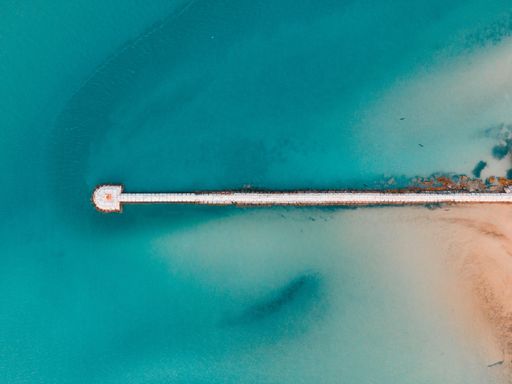 Aerial view at sunset of the marina in the bay ,blue sea and white sandy beach in Rio Lagartos, Mexico, concept -vacation, summer