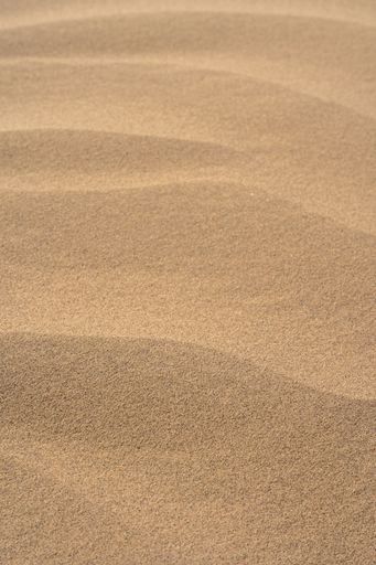 A vertical shot of sand dunes texture in a desert