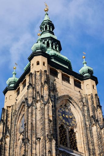 A low-angle vertical shot of the St. Vitus Cathedral City of Prague under a blue sky