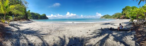 A panoramic shot of the sandy beach of the Pacific Ocean in Costa Rica